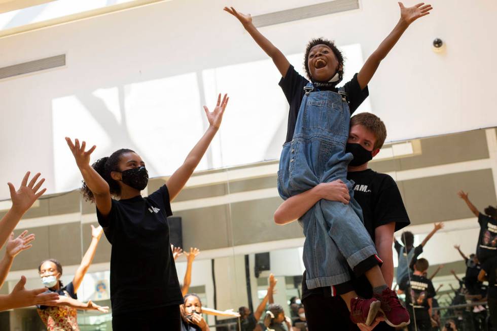 Koston Pobon picks up Micha Marino, who plays Andie, during a rehearsal for Broadway at HOOD's ...
