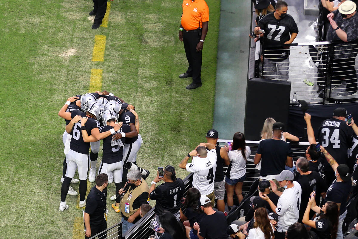 Las Vegas Raiders players huddle before the start of a NFL preseason game against the Seattle S ...