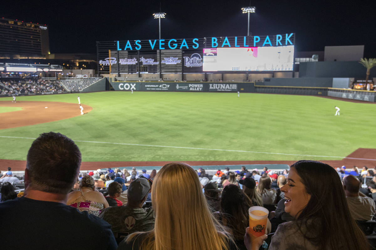 Jamie Lewis, right, laughs with her friend Nettie Byerly, center, during a Las Vegas Aviators g ...