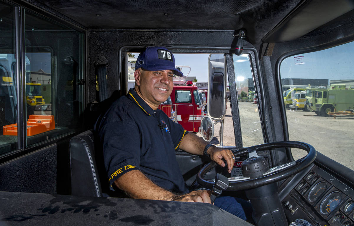 Retired New York firefighter Frank Pizarro poses for a photo inside the cab of his 1991 Pierce ...