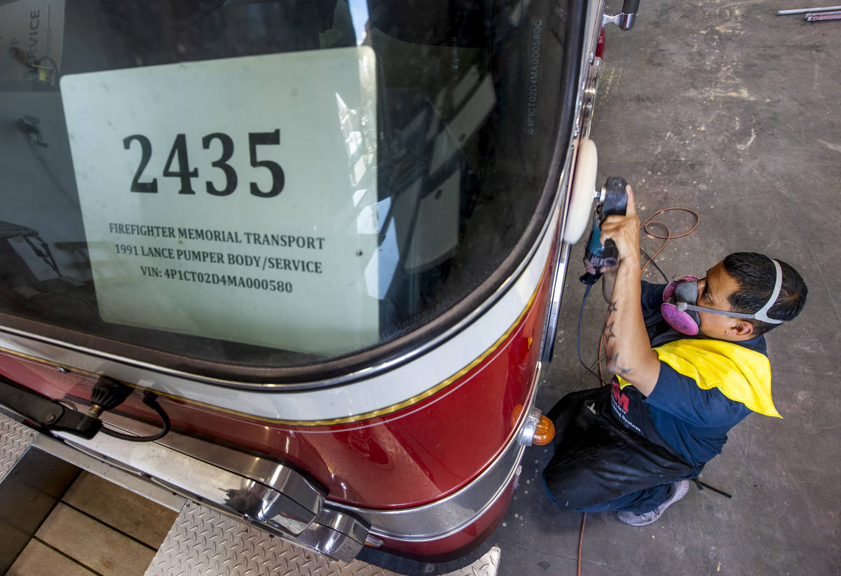Horacio Sanchez buffs out the side of Frank Pizarro's 1991 Pierce firetruck at Firetrucks Unlim ...