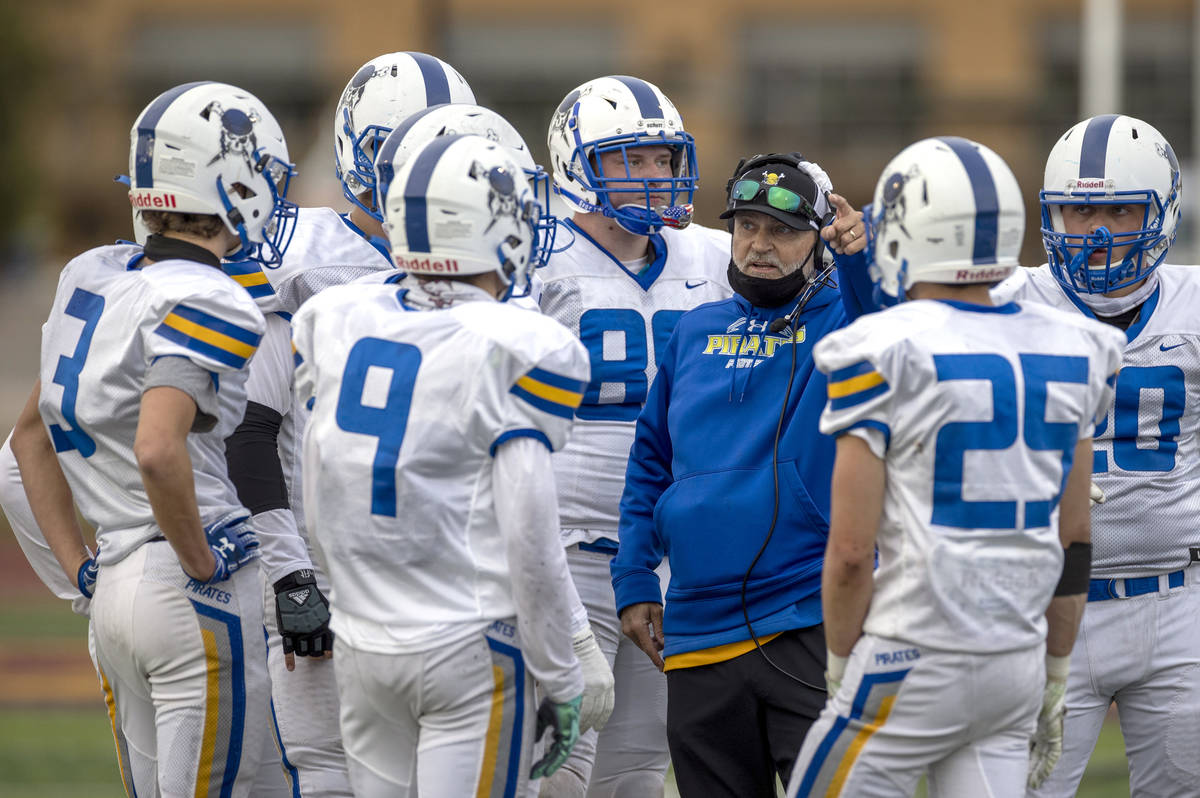 Moapa Valley coach Brent Lewis counsels his players as Faith Lutheran leads during the second q ...