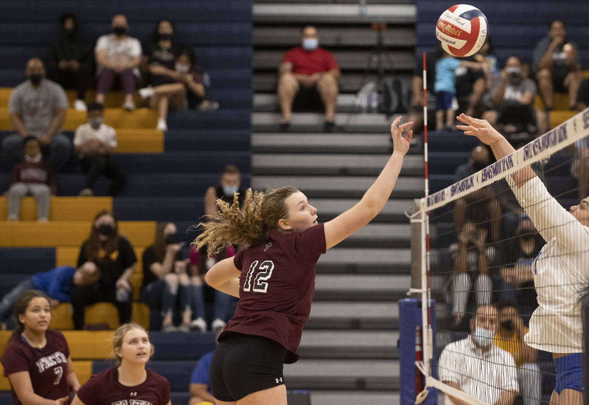 Faith Lutheran’s Delaney Wilson (12) leaps to block a shot during a girls high school vo ...