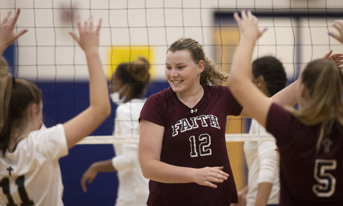 Faith Lutheran’s Delaney Wilson (12) celebrates a big play with teammates during a girls ...