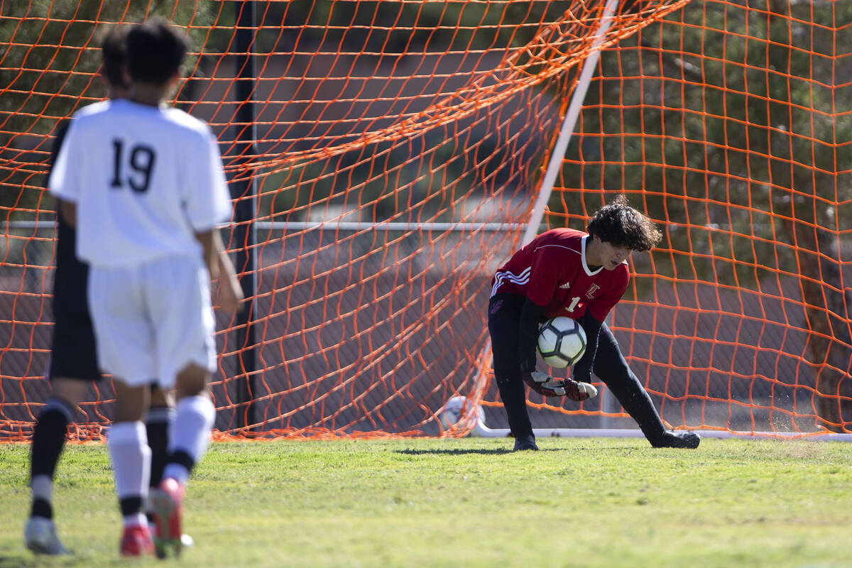 Liberty's Kristopher Cordero (1) saves a shot by Palo Verde during a high school soccer game at ...