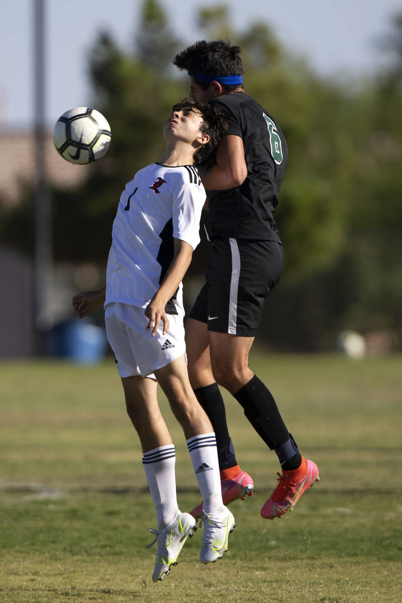 Liberty's Kristopher Cordero (1) and Palo Verde's Ethan Oiknine (9) collide while they go for a ...