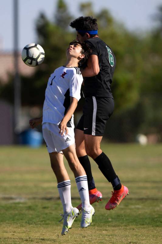 Liberty's Kristopher Cordero (1) and Palo Verde's Ethan Oiknine (9) collide while they go for a ...
