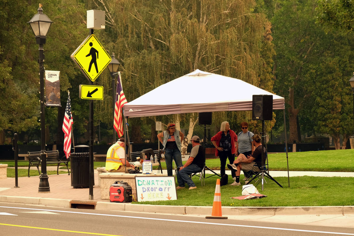 Volunteers in Carson City set up a tent on Carson Street to receive donations of water, blanket ...