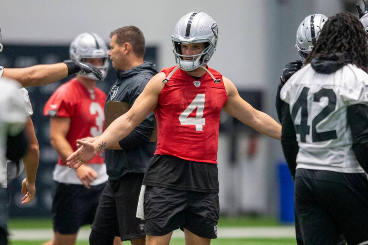 Raiders quarterback Derek Carr (4) greets players as they walk in to huddle during team practic ...