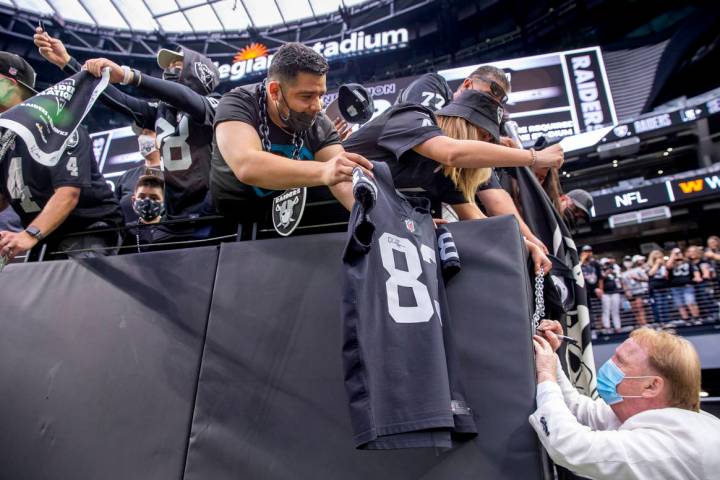 Raiders owner Mark Davis signs autographs for fans before the Raiders home opening preseason ga ...