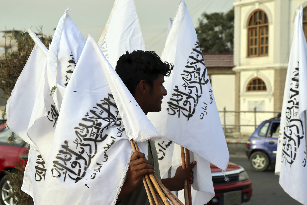 A man sells Taliban flags in Kabul, Afghanistan, Monday, Aug. 30, 2021. Many Afghans are anxiou ...