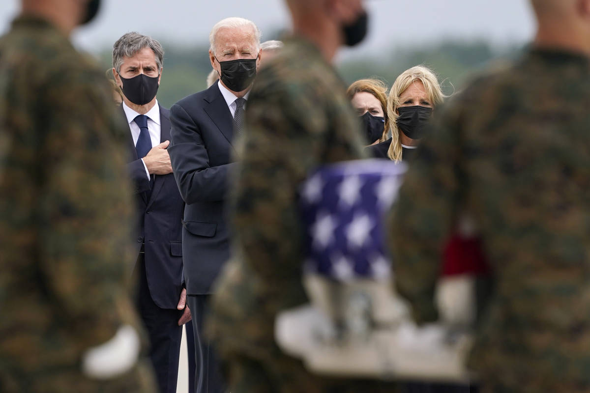 President Joe Biden looks on at a transfer case with the remains of Marine Corps Cpl. Humberto ...