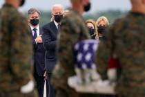 President Joe Biden looks on at a transfer case with the remains of Marine Corps Cpl. Humberto ...