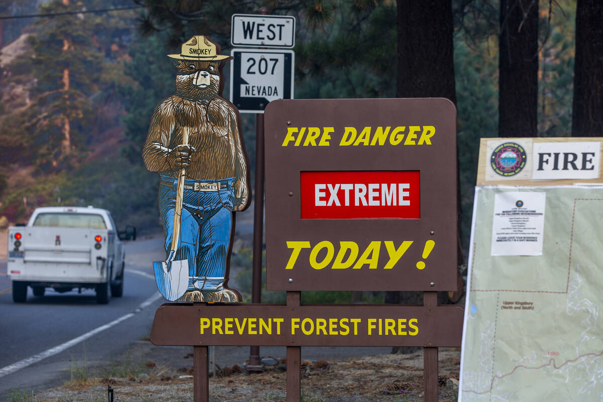 The fire danger is still rated extreme as Smokey the Bear stands by off of SR 207 as the Caldor ...