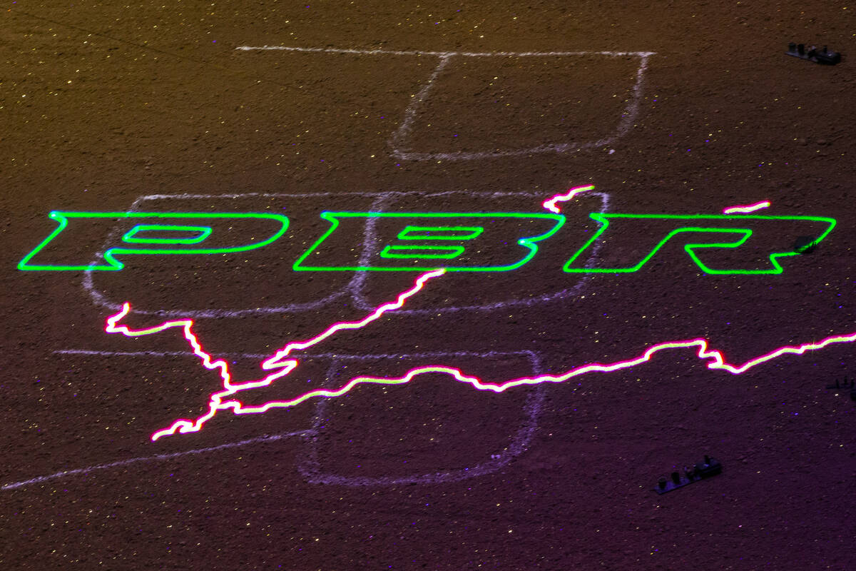 A PBR logo with lightning projected on the dirt ring during the last day of the PBR World Final ...