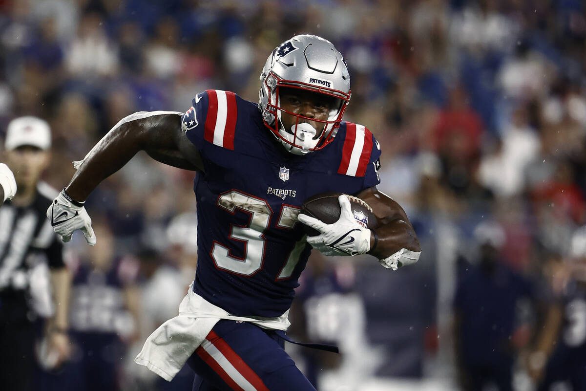 New England Patriots' Damien Harris runs against the Washington Football Team during an NFL pre ...