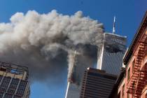 In this Sept. 11, 2001, file photo, smoke rises from the burning twin towers of the World Trade ...