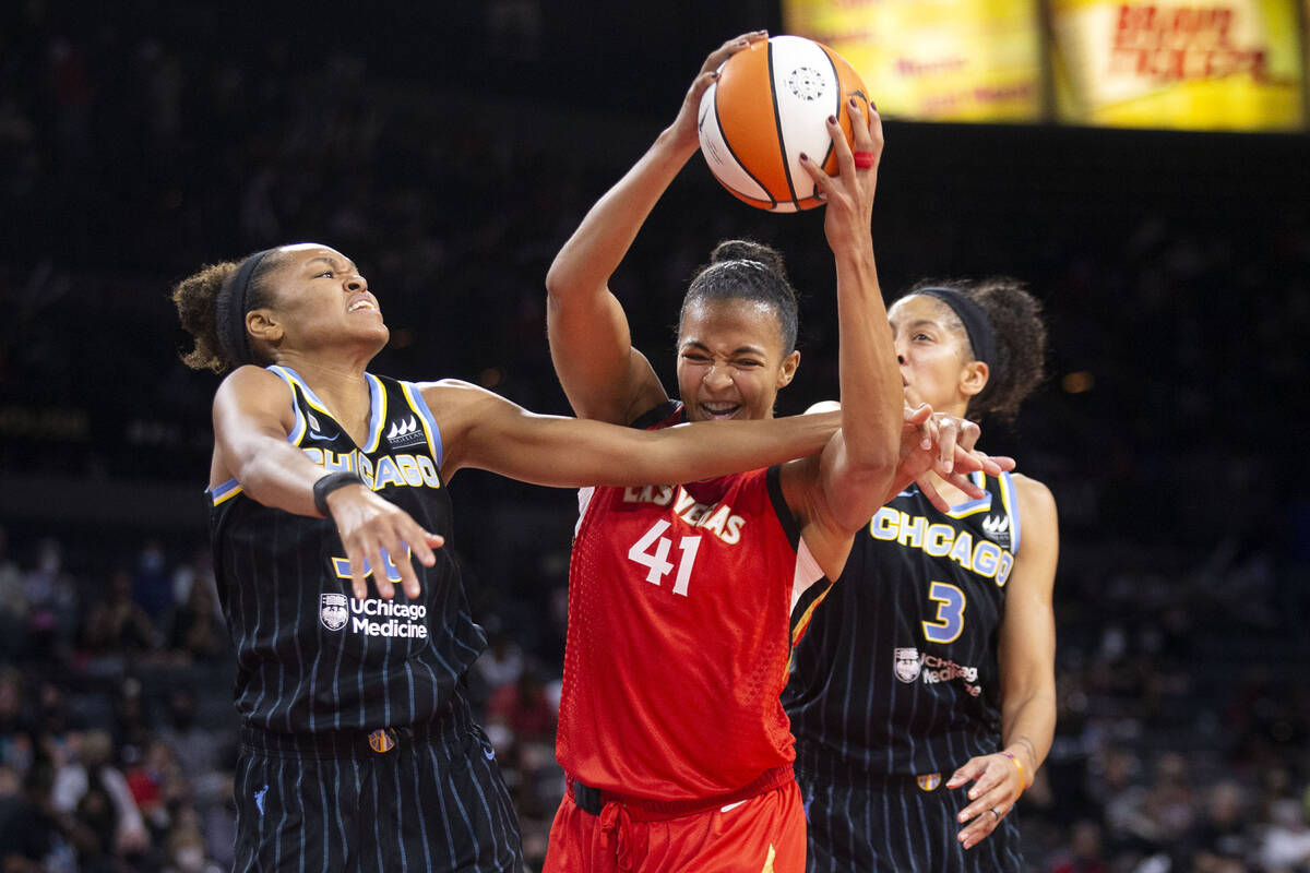 Las Vegas Aces center Kiah Stokes (41) gains control of the ball alongside Chicago Sky forward/ ...