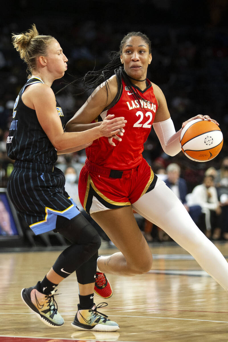 Las Vegas Aces forward A'ja Wilson (22) dribbles around Chicago Sky guard Courtney Vandersloot ...