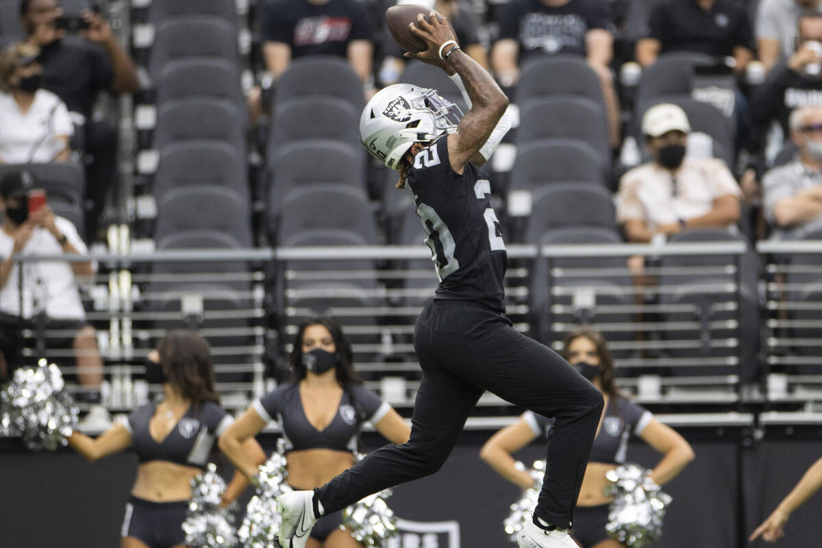Raiders cornerback Damon Arnette (20) makes a leaping catch during a special training camp prac ...