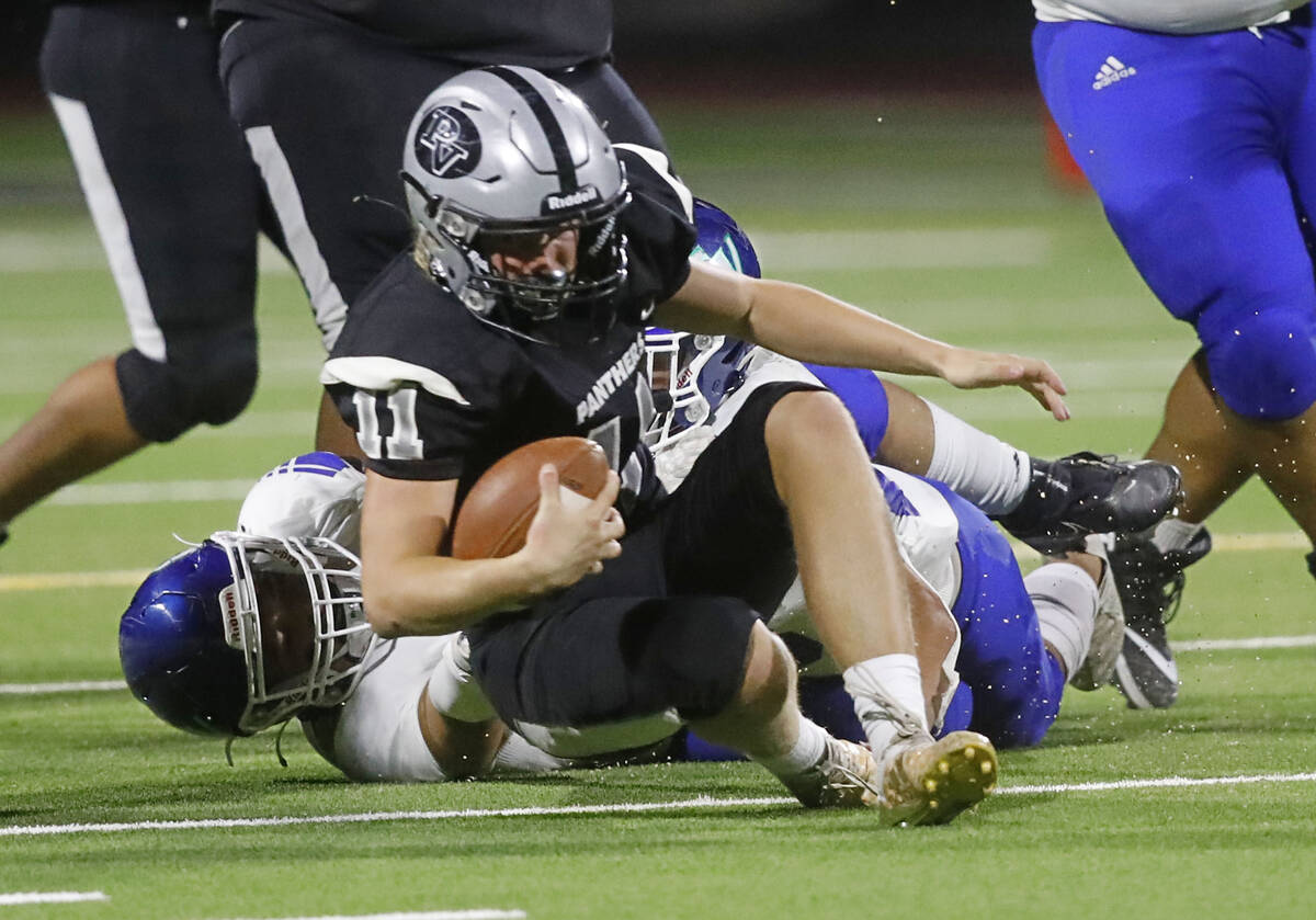 Palo Verde High School's quarterback Brady DeNardin (11) is sacked by Green Valley High School ...