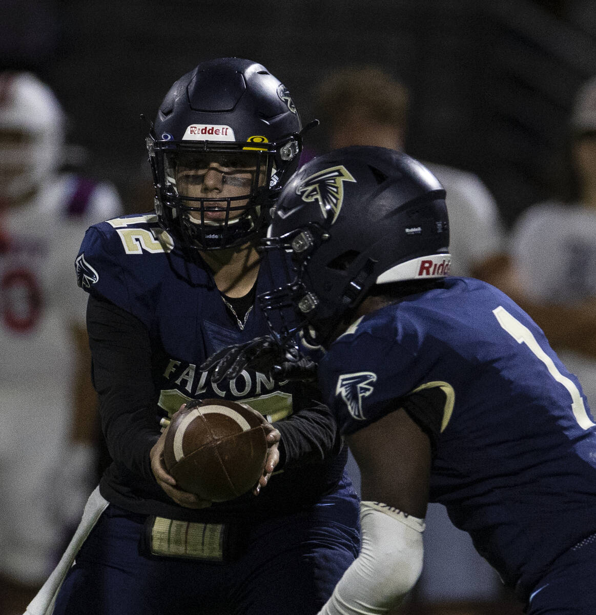 Foothill HighÕs quarterback Cameron Paul (12) hands the ball off to running back Kendric T ...