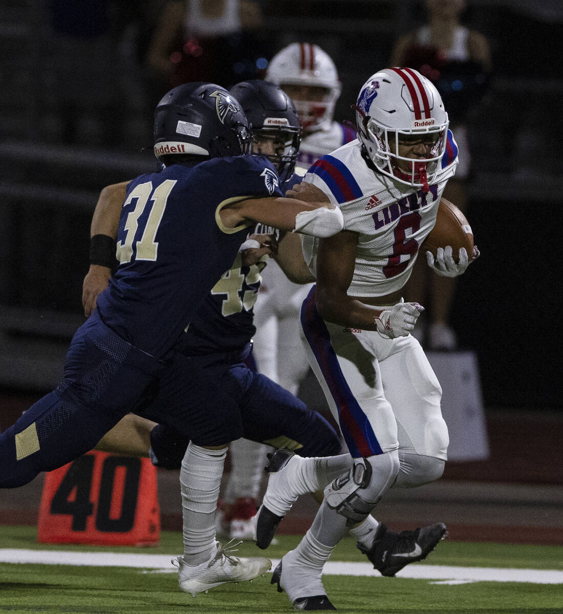 Liberty HighÕs wide receiver Marques Johnson (6) runs with the ball as Foothill HighÕ ...