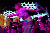 Stacy Tally, of Florida, hoops during the Lost in Dreams music festival at the Downtown Las Veg ...