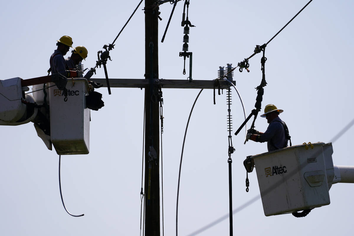 Crews work on power lines that were damaged in the aftermath of Hurricane Ida, Friday, Sept. 3, ...