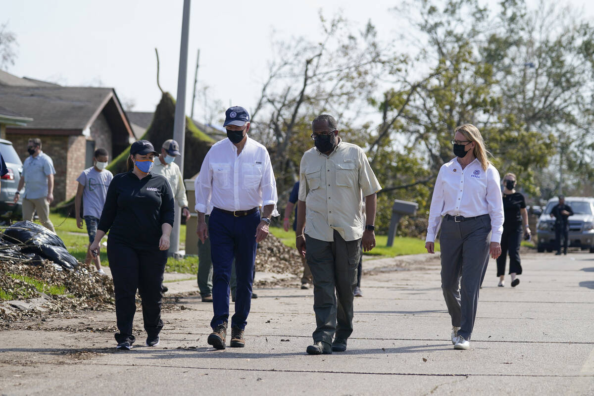President Joe Biden tours a neighborhood impacted by Hurricane Ida, Friday, Sept. 3, 2021, in L ...
