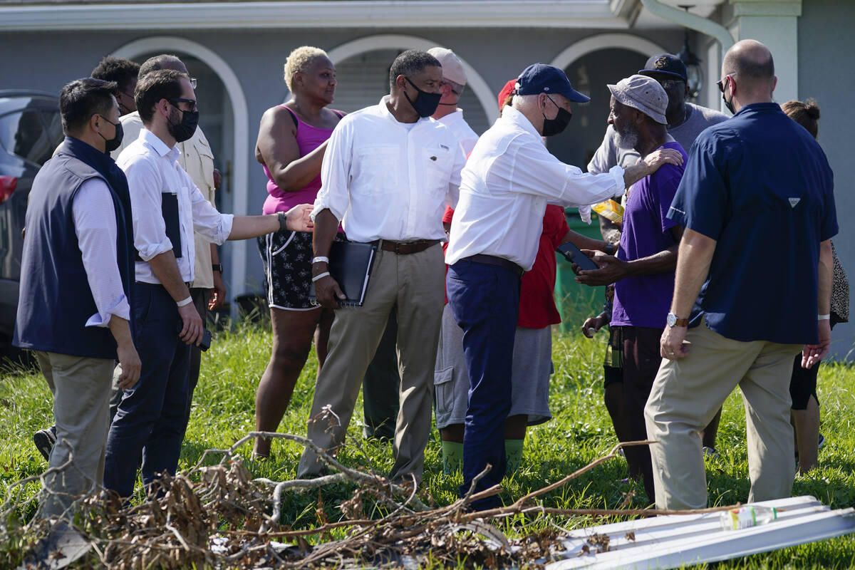 President Joe Biden greets a resident as he tours a neighborhood impacted by Hurricane Ida, Fri ...