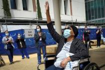 Karen Parker-Bryant, 64, raises a hand skyward after she was released from Clovis Community Hos ...