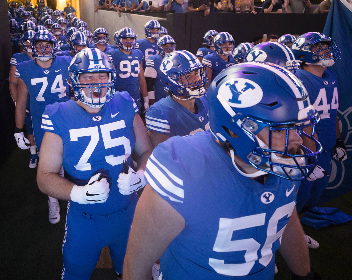 Brigham Young players take the field before the start of a college football game against the Ar ...