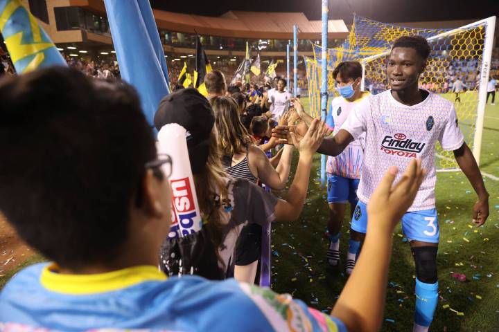 Las Vegas Lights Mohamed Traore high fives fans at the end of an USL Championship soccer game a ...