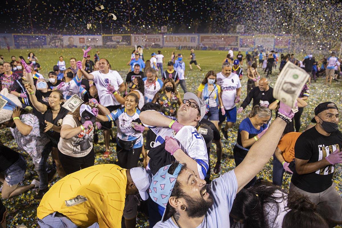 People scramble for money during the annual “$5,000 Cash Drop presented by Jarritos&#x20 ...