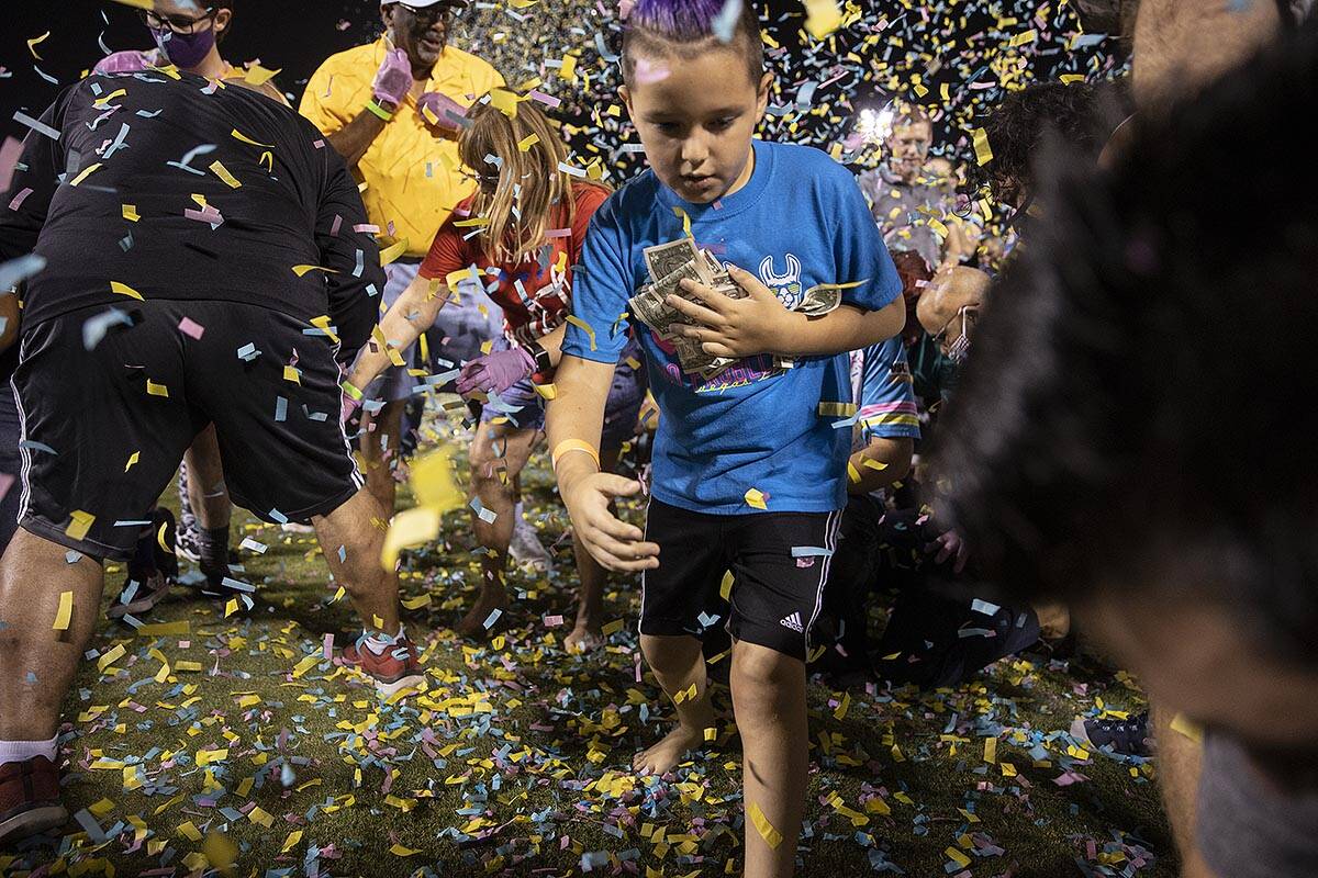 People scramble for money during the annual “$5,000 Cash Drop presented by Jarritos&#x20 ...