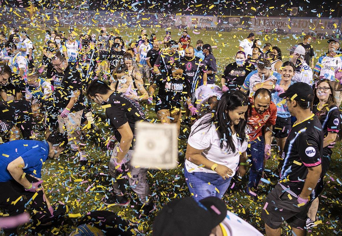 People scramble for money during the annual “$5,000 Cash Drop presented by Jarritos&#x20 ...