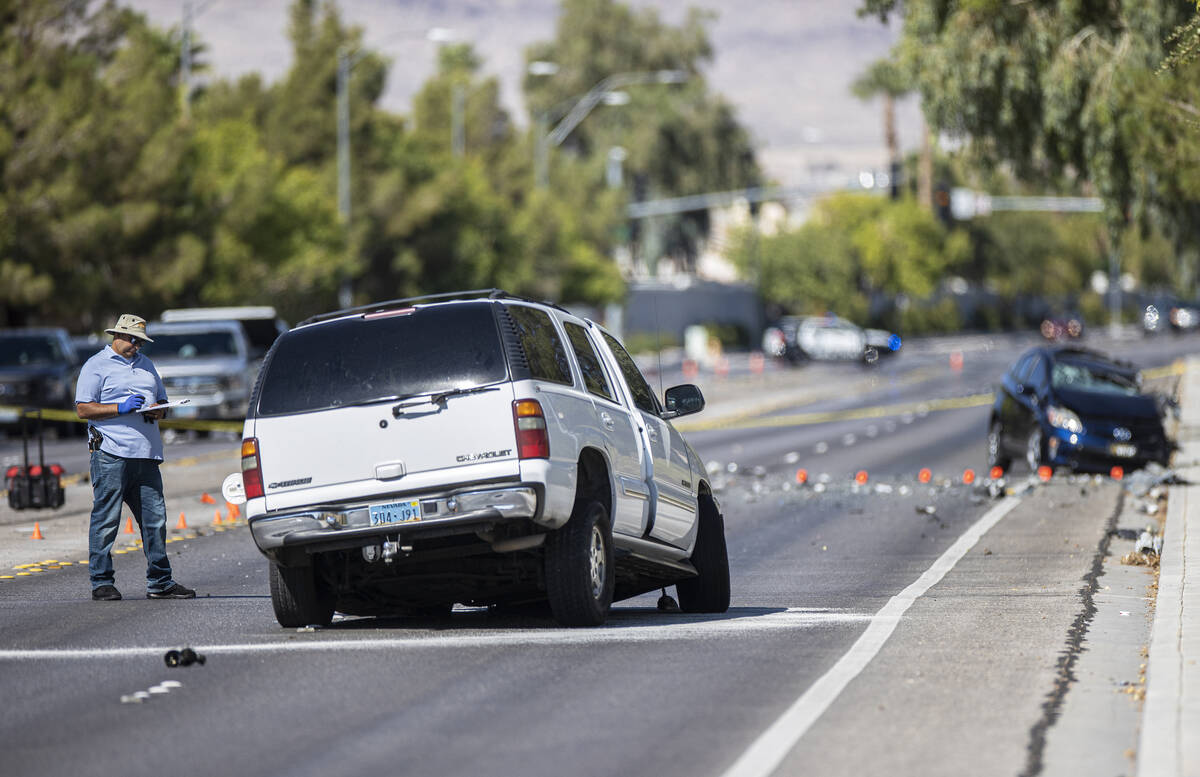 Law enforcement investigates a fatal car crash near North Tenaya Way and Farm Road on Monday, S ...