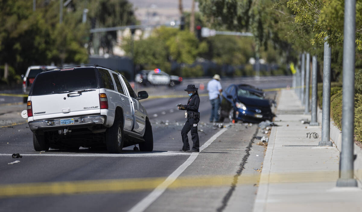 Law enforcement investigates a fatal car crash near North Tenaya Way and Farm Road on Monday, S ...