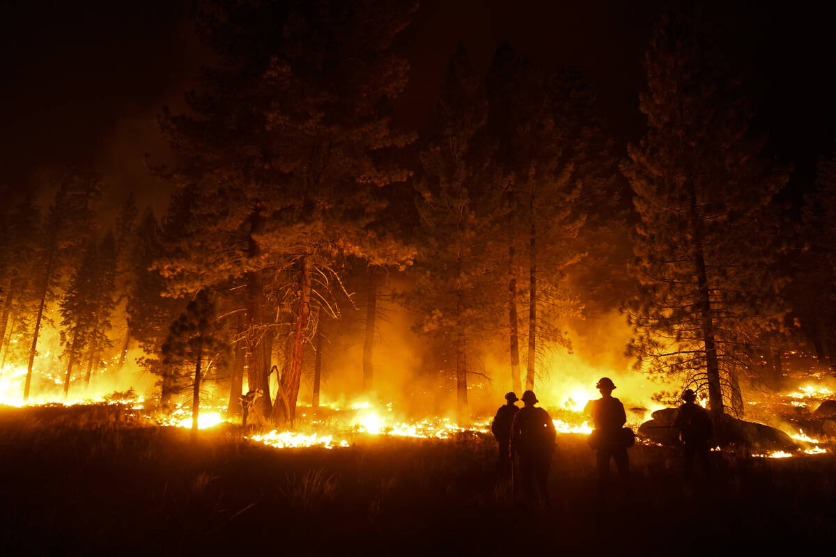 FILE - In this Sept. 1, 2021, file photo, a firefighter lights a backfire to stop the Caldor Fi ...