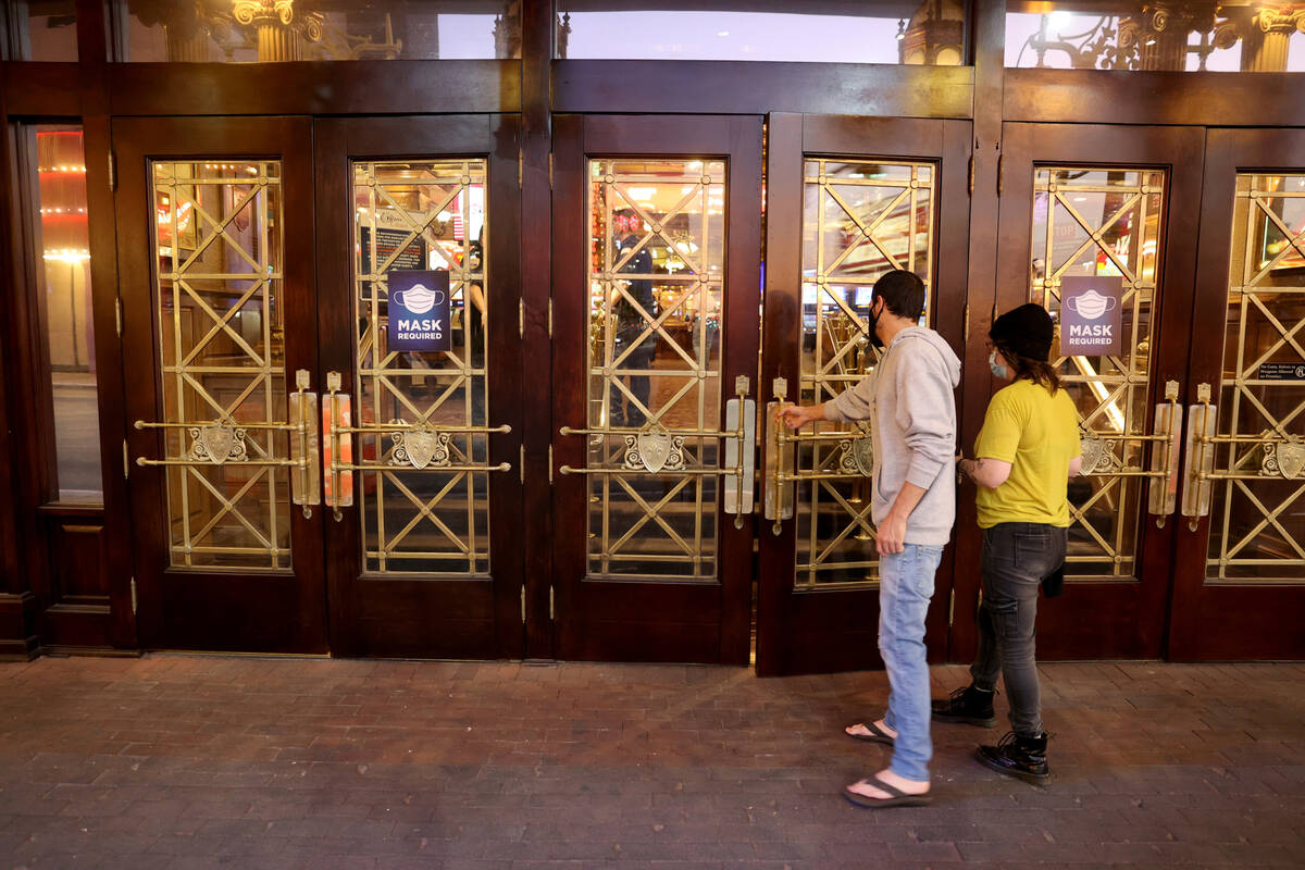 People walk into Main Street Station at the 6 a.m. reopening of the hotel-casino in downtown La ...