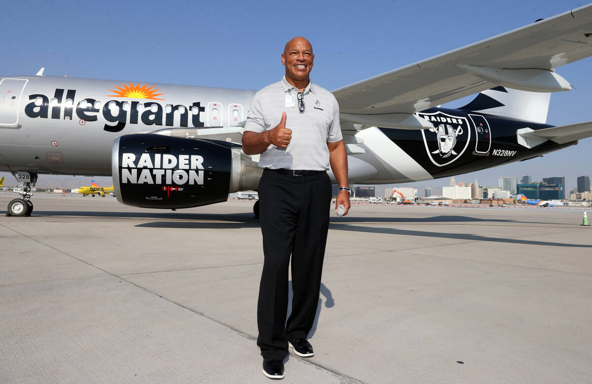 Raiders alumnus Greg Townsend shows off Allegiant Air’s Raiders-themed aircraft at McCar ...