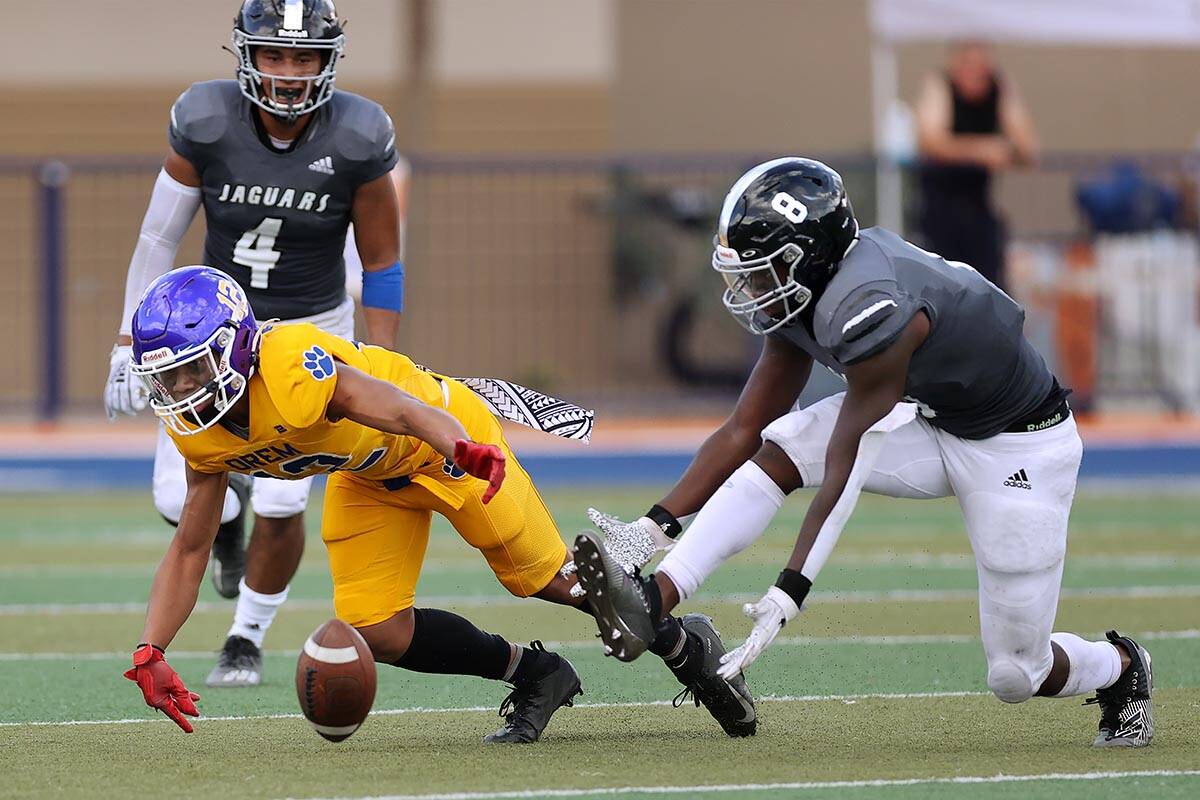 Orem's Tyson Ngaya (12) and Desert Pines' Labarrio Mays (8), dive short of the ball in the seco ...