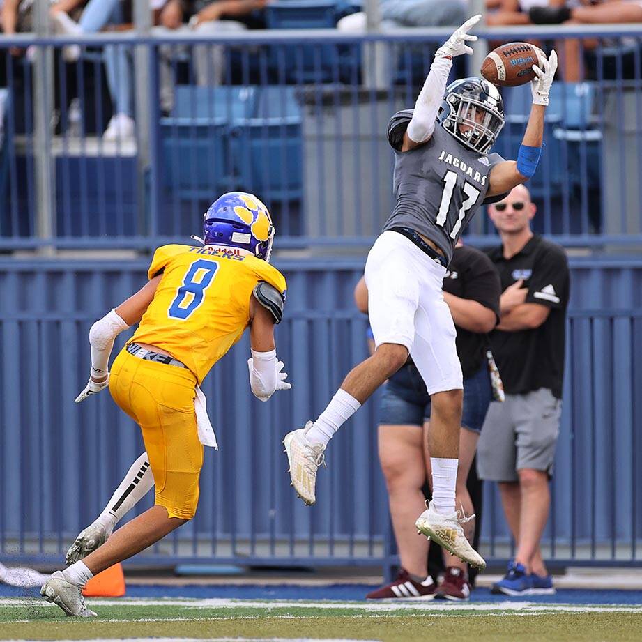 Desert Pines' Josiah Barron (17) makes a catch under pressure from Orem's Jaxon Beckstrom (8) i ...