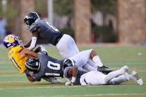 Desert Pines' Labarrio Mays (8) and Malik Stinnett (10) tackle Orem's Isaac Yokota (11) in the ...