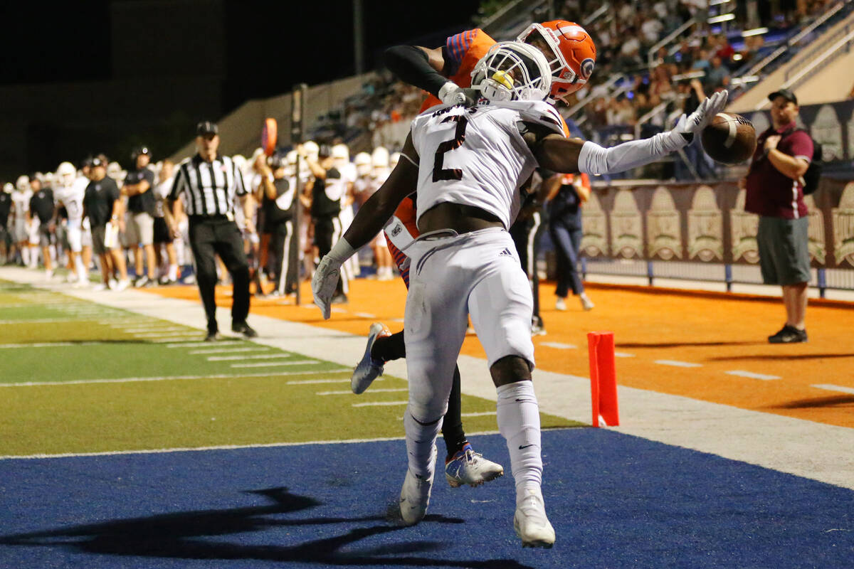 Bishop Gorman's Fabian Ross (4) interferes with a pass intended for Lone Peak's Luke Hyde (2) i ...