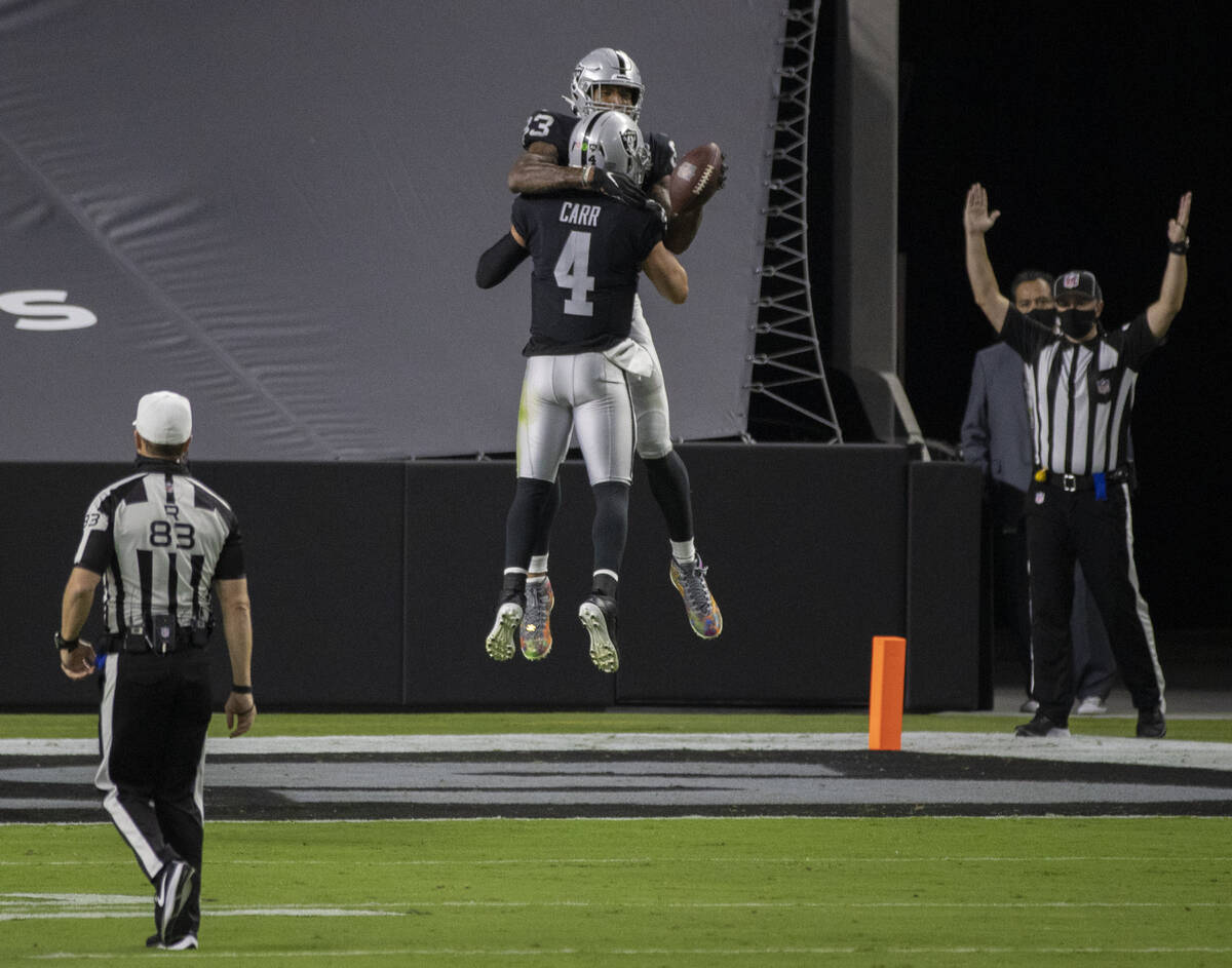 Las Vegas Raiders quarterback Derek Carr (4) celebrates with Las Vegas Raiders tight end Darren ...