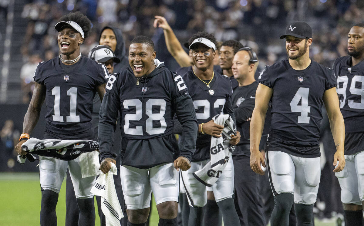 (From left) Raiders wide receiver Henry Ruggs III (11), running back Josh Jacobs (28), running ...