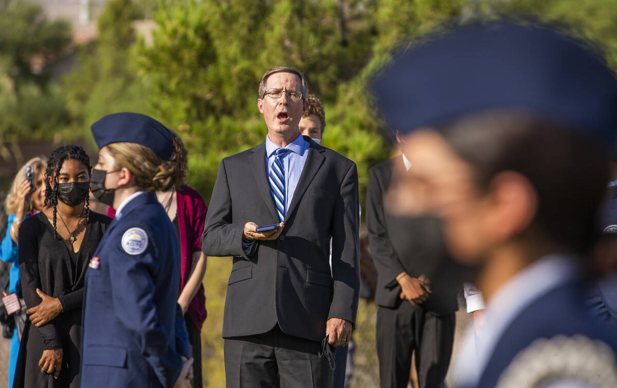 Palo Verde High School choir director Barry Isbel sings during a ceremony to honor the memory o ...