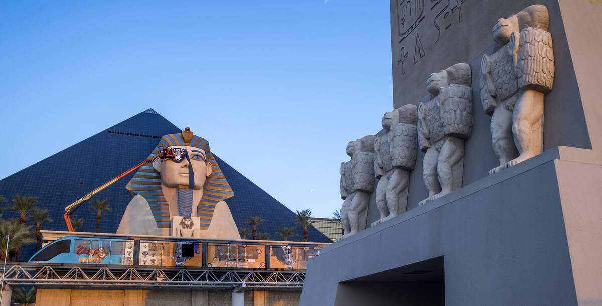 A team from Access Solutions hangs a Raiders eye patch on the Great Sphinx of Giza replica outs ...